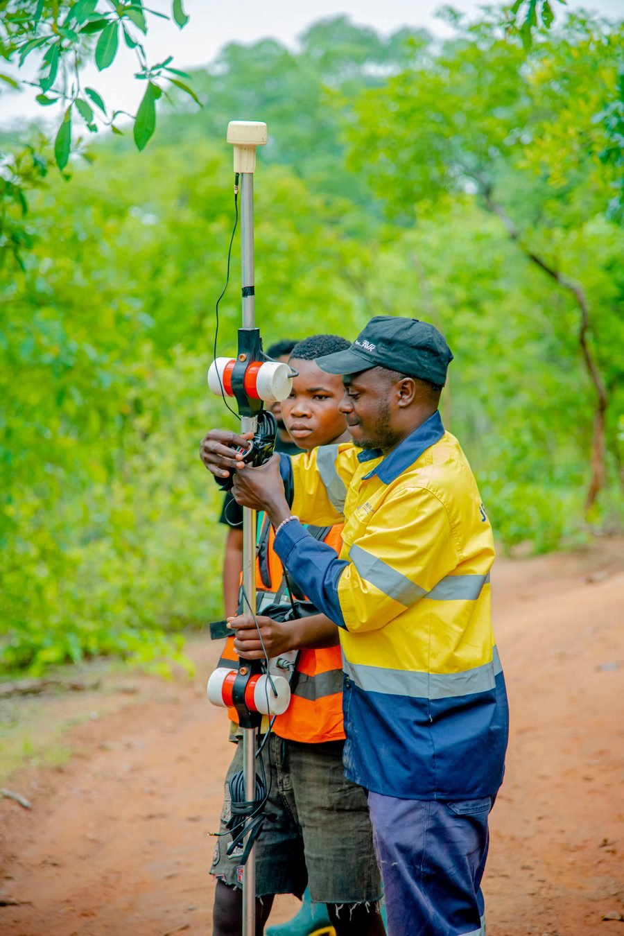 Field team setting up survey instrumentation on a traverse